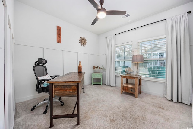 carpeted office with ceiling fan