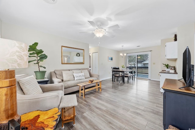 living room featuring ceiling fan and light hardwood / wood-style floors