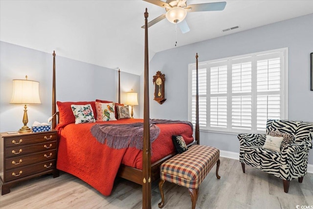 bedroom featuring ceiling fan, lofted ceiling, and light hardwood / wood-style floors