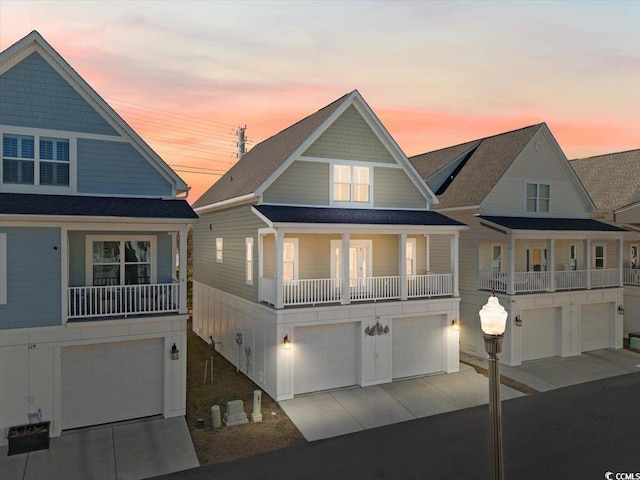 view of front facade featuring a garage and a balcony