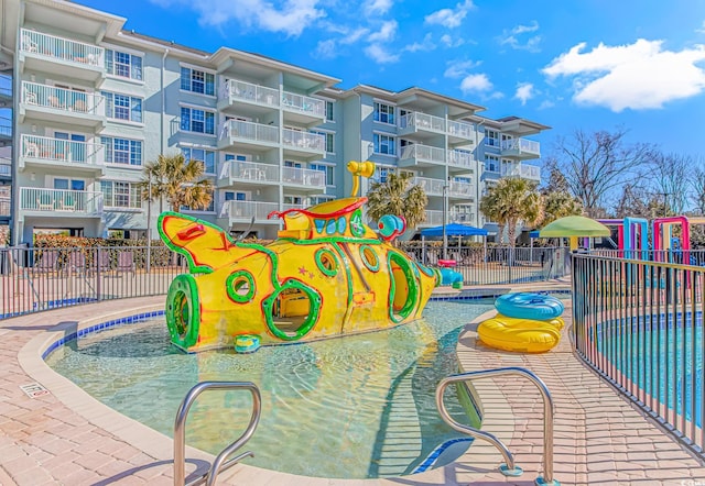 view of playground with a community pool