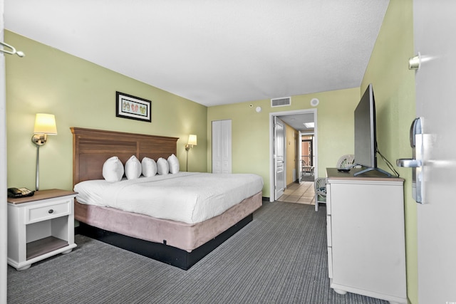 bedroom with dark colored carpet