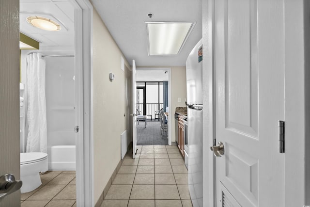 corridor featuring light tile patterned floors