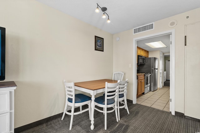 dining room featuring light colored carpet