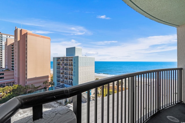 balcony featuring a water view and a beach view