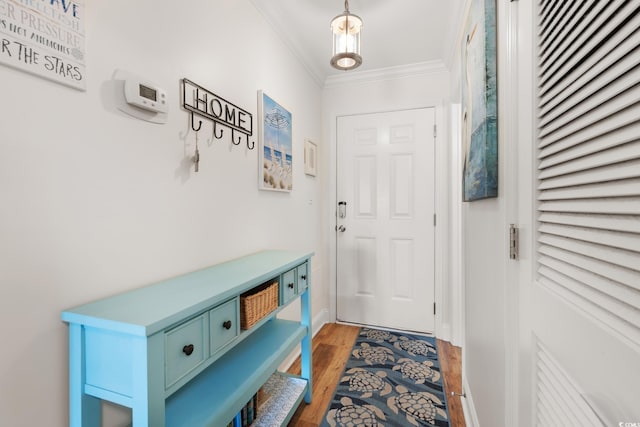 doorway to outside featuring hardwood / wood-style flooring and ornamental molding