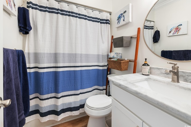 bathroom with walk in shower, toilet, crown molding, vanity, and hardwood / wood-style floors