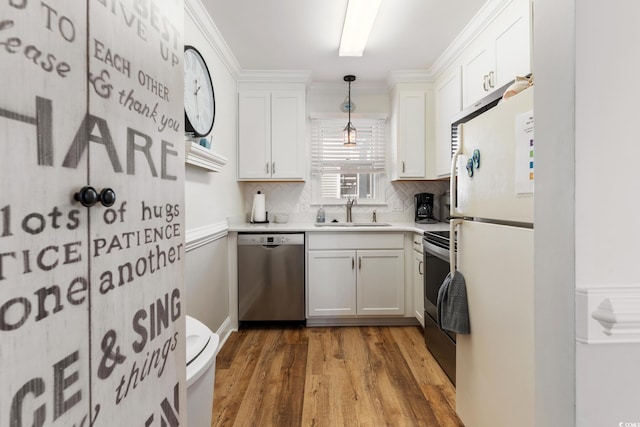 kitchen featuring decorative light fixtures, white cabinetry, sink, decorative backsplash, and stainless steel appliances