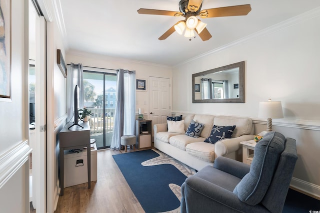 living room with ornamental molding, hardwood / wood-style floors, and ceiling fan