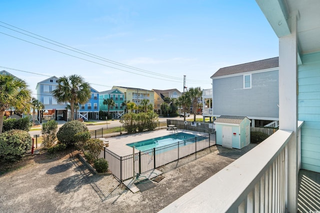 view of swimming pool with a shed