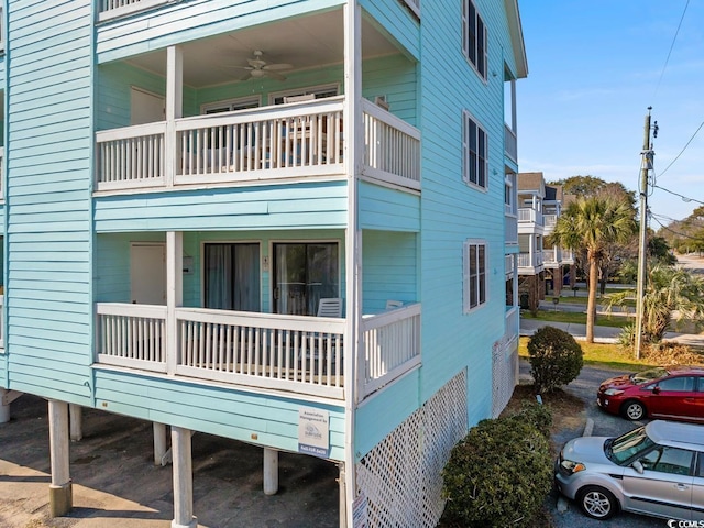 view of home's exterior with a balcony and ceiling fan