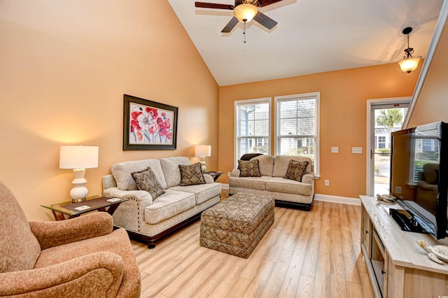 living room with light hardwood / wood-style flooring, high vaulted ceiling, and ceiling fan