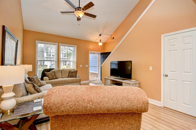 living room with vaulted ceiling, light hardwood / wood-style floors, and ceiling fan