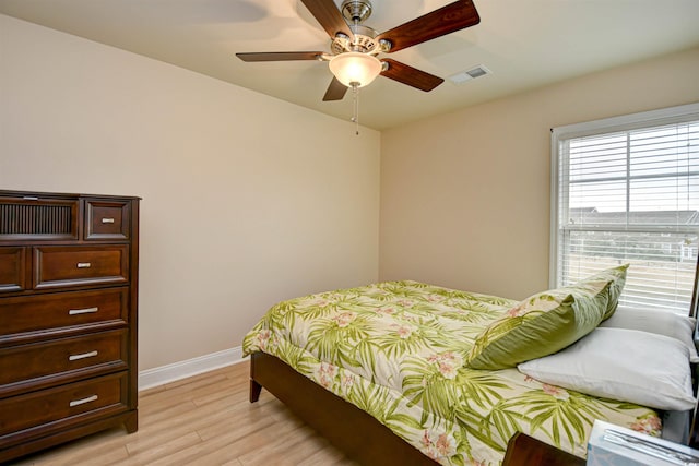 bedroom with ceiling fan and light hardwood / wood-style floors