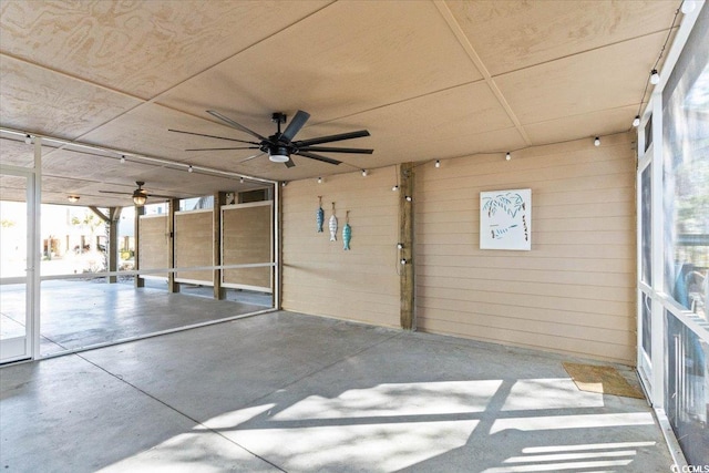 garage with wooden walls and ceiling fan