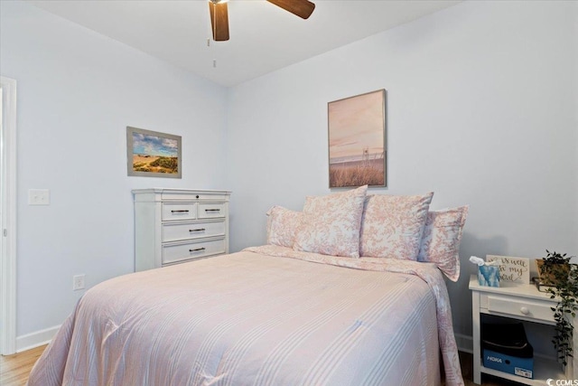 bedroom with light hardwood / wood-style floors and ceiling fan