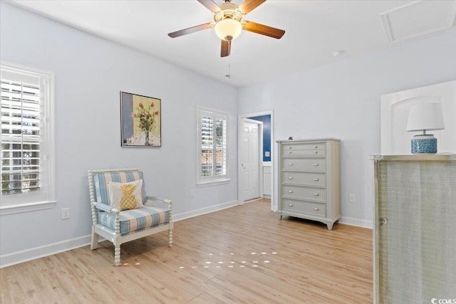 living area with ceiling fan and light hardwood / wood-style floors