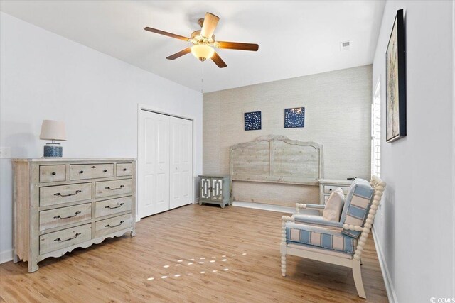 sitting room with ceiling fan and light hardwood / wood-style floors