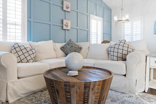 living room with hardwood / wood-style floors and an inviting chandelier