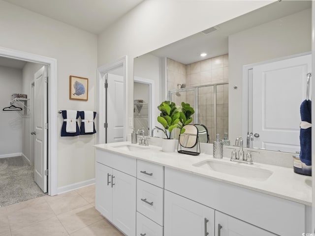 bathroom with tile patterned floors, vanity, and a shower with door