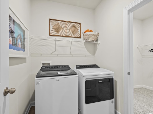 clothes washing area with washing machine and clothes dryer and carpet flooring