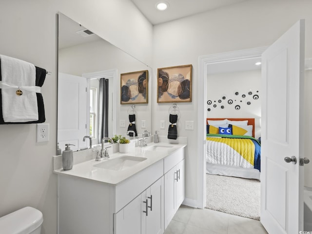 bathroom featuring vanity, tile patterned floors, and toilet