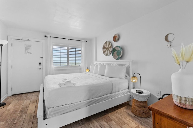 bedroom with hardwood / wood-style flooring