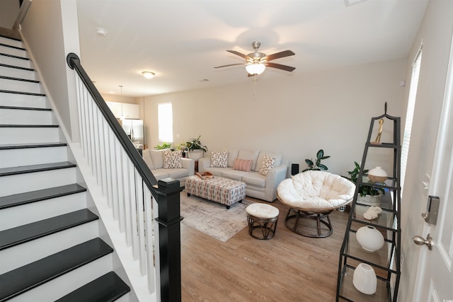 living room featuring ceiling fan and light wood-type flooring