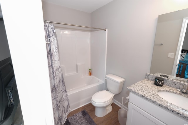 full bathroom featuring vanity, wood-type flooring, shower / tub combo with curtain, and toilet