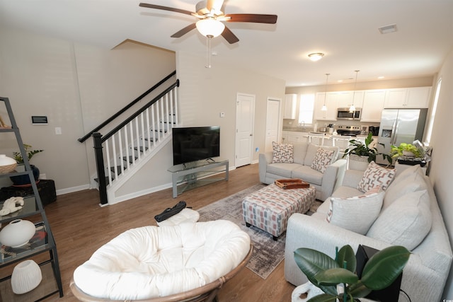 living room with hardwood / wood-style floors and ceiling fan