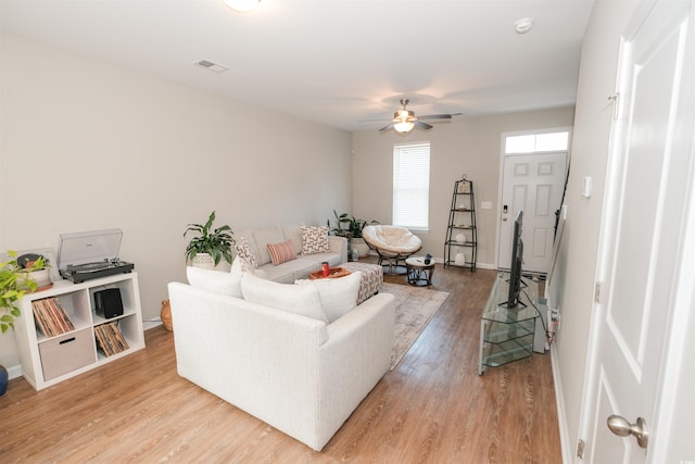 living room featuring ceiling fan and light wood-type flooring