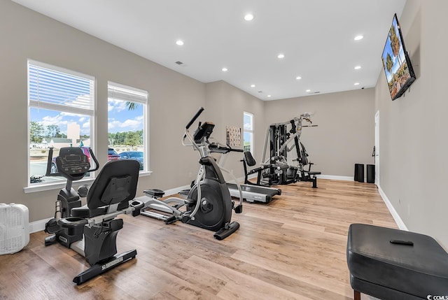 workout room with plenty of natural light and light wood-type flooring