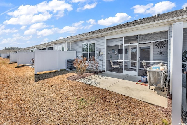 rear view of house with central AC, a sunroom, and a patio