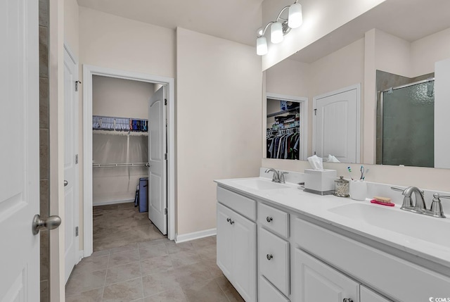 bathroom with vanity, an enclosed shower, and tile patterned floors