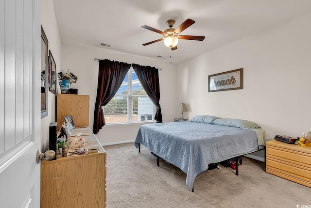 bedroom with light carpet and ceiling fan