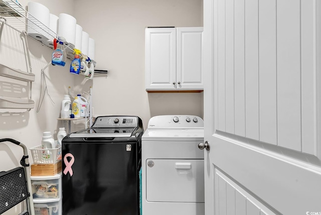 laundry room featuring independent washer and dryer and cabinets