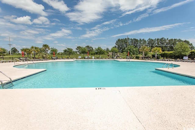 view of swimming pool featuring a patio