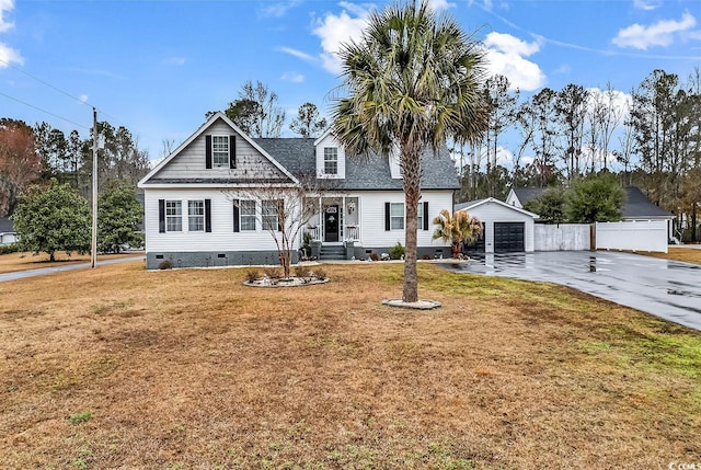 view of front of home featuring an outbuilding, a garage, and a front lawn