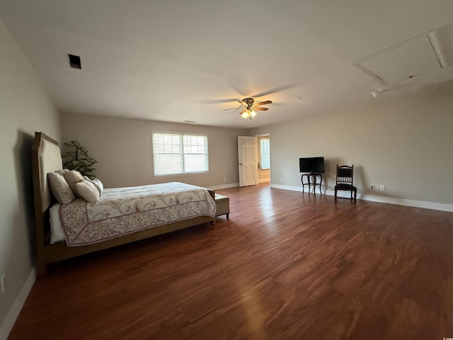 bedroom with dark hardwood / wood-style flooring and ceiling fan