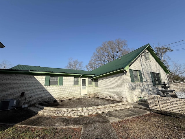 back of house with central AC unit