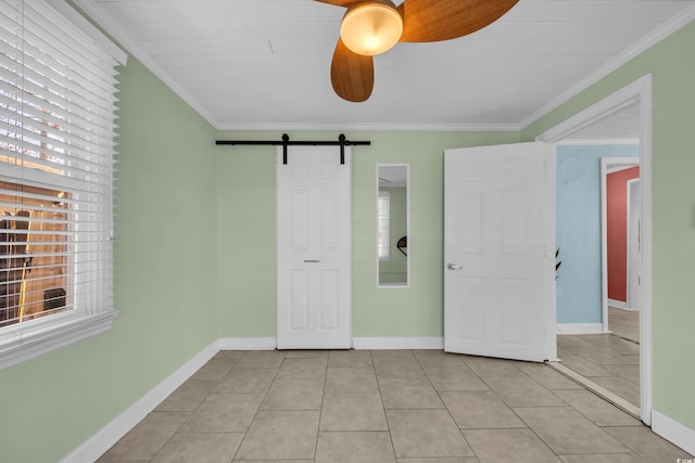 unfurnished bedroom with multiple windows, light tile patterned floors, ornamental molding, and a barn door