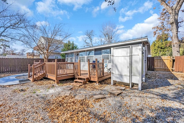 rear view of property with a wooden deck