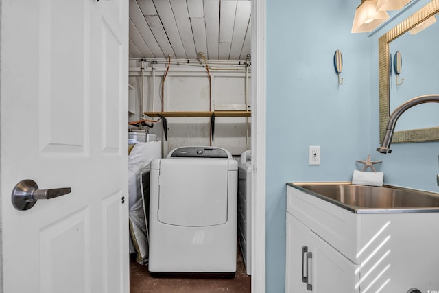 clothes washing area with sink and washer and dryer