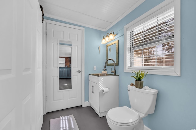 bathroom with vanity, ornamental molding, concrete flooring, and toilet