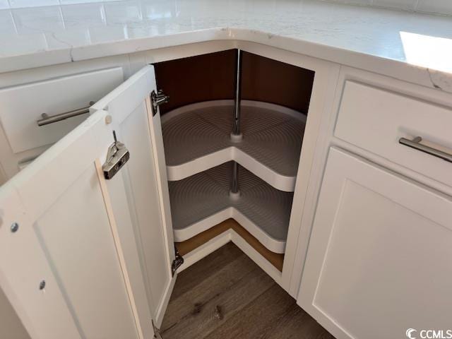 details with white cabinetry and dark hardwood / wood-style floors