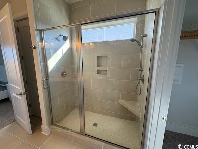 bathroom featuring an enclosed shower and tile patterned floors