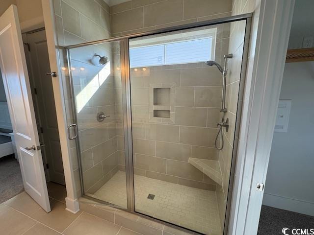 full bath with a stall shower and tile patterned floors
