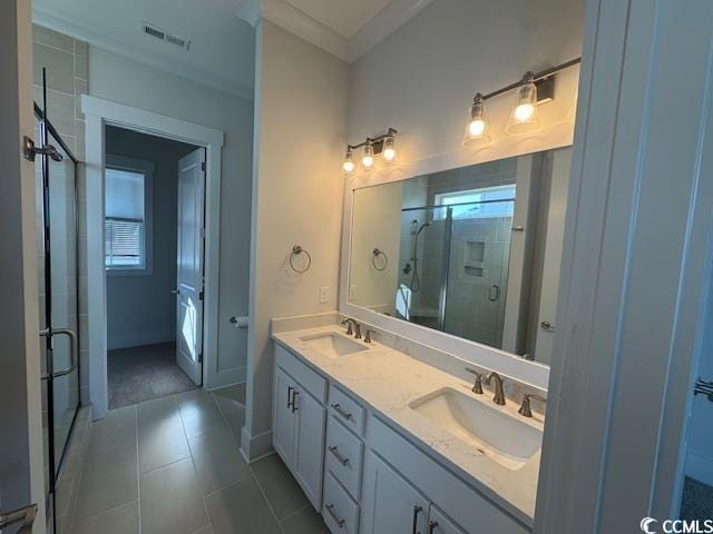 full bathroom with crown molding, a shower stall, a sink, visible vents, and double vanity