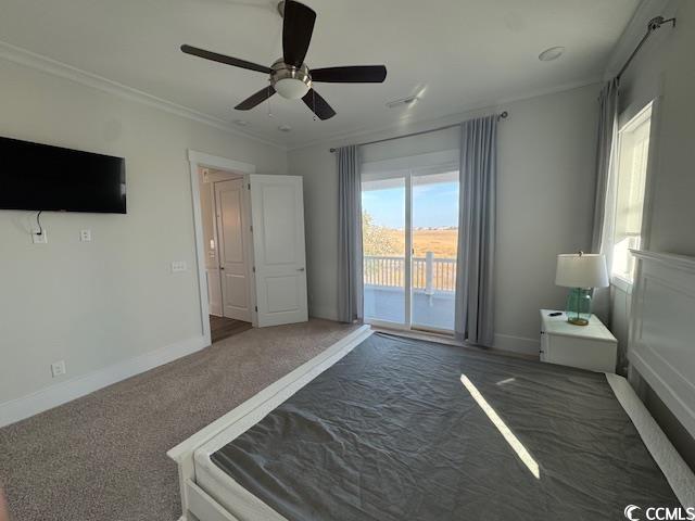 unfurnished bedroom featuring access to exterior, carpet floors, a ceiling fan, baseboards, and ornamental molding