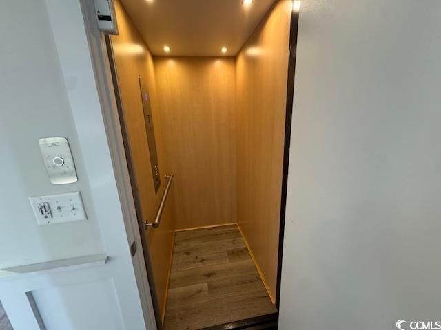 room details featuring elevator and hardwood / wood-style floors